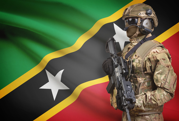 The flag of St. Kitts and Nevis and heavily armed soldiers