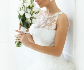White wedding dress holding a bouquet of brides Stock Photo