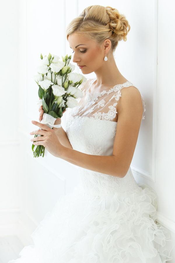 White wedding dress holding a bouquet of brides Stock Photo
