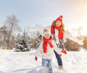 Winter Mother and daughter playing snow outdoors Stock Photo 01