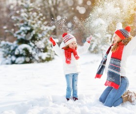 Winter Mother and daughter playing snow outdoors Stock Photo 03