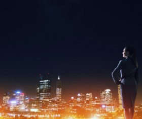 Woman looking at night city stock photo 11