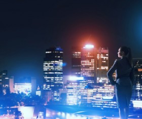 Woman looking at night city stock photo 12