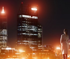 Woman looking at night city stock photo 13