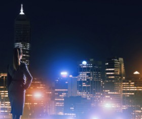 Woman looking at night city stock photo 14