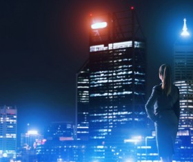 Woman looking at night city stock photo 15