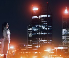 Woman looking at night city stock photo 17