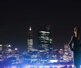 Woman looking at night city stock photo 18