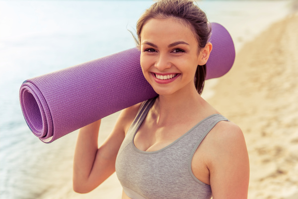Yoga mat Smiling woman Stock Photo