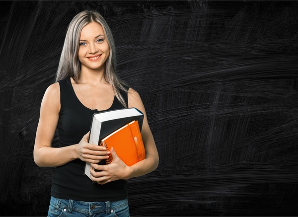 Young girl with books and blackboard HD picture