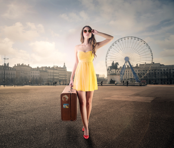 A female tourist carrying luggage Stock Photo