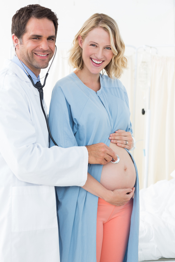 Doctor examining pregnant woman Stock Photo