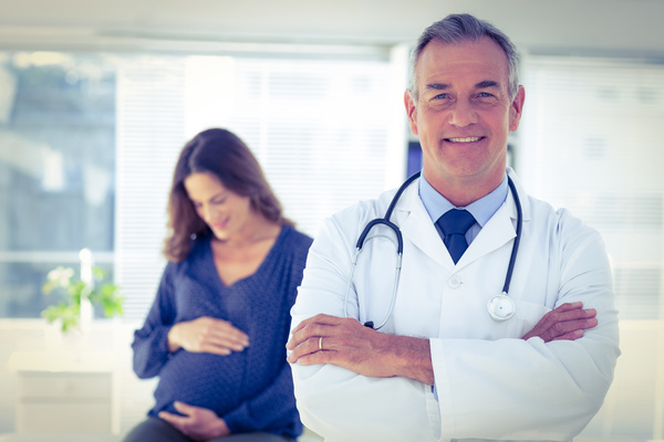 Doctor with pregnant woman Stock Photo