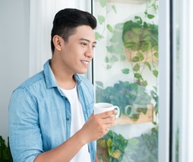 Enjoy the plants outside the window of the man Stock Photo