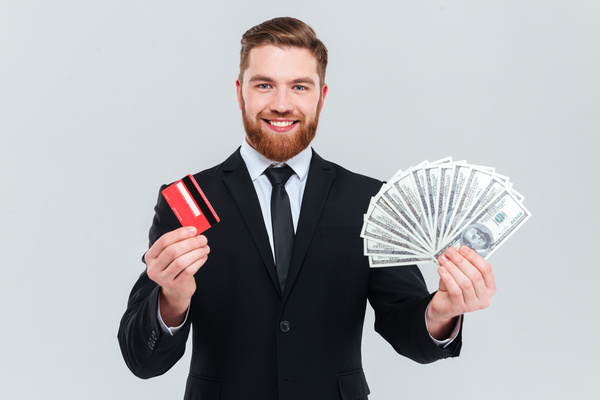Hand holding bank card businessman, dollar bills Stock Photo