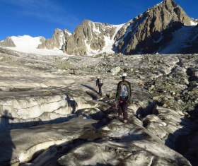 People climbing snow-capped mountains Stock Photo