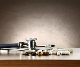 Stethoscope on tabletop and pill Stock Photo