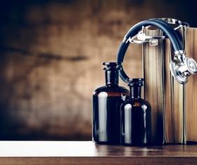 Stethoscope on the table and books and vials Stock Photo 01