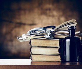 Stethoscope on the table and books and vials Stock Photo 02