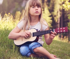 The little girl plays ukree Stock Photo