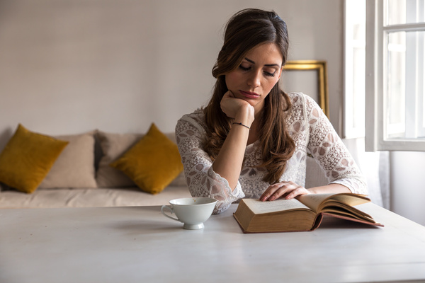 Woman reading with coffee Stock Photo