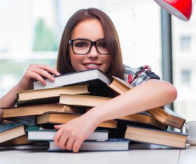 Young female student holding books HD picture