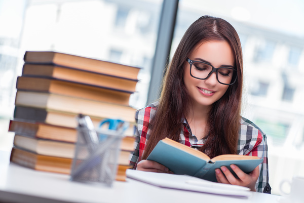 Young female student reading HD picture