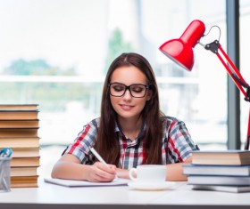 Young woman writing notes and books HD picture
