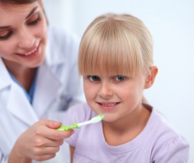 Doctors teach children to brush their teeth Stock Photo