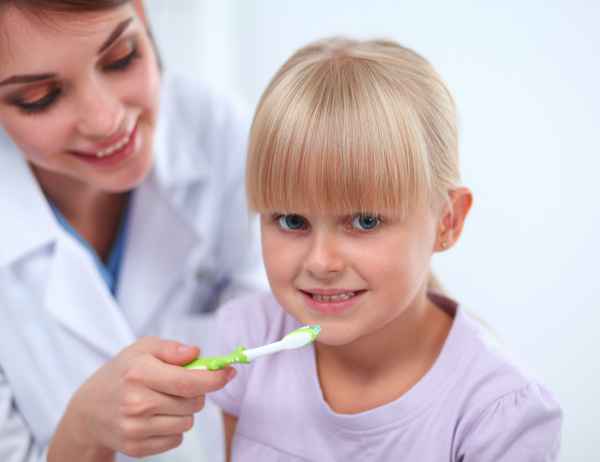 Doctors teach children to brush their teeth Stock Photo