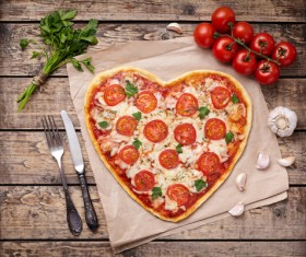 Heart-shaped pizza with tomato Stock Photo
