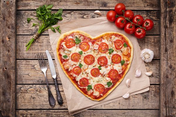 Heart-shaped pizza with tomato Stock Photo