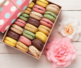 Macaron and flowers on the table Stock Photo
