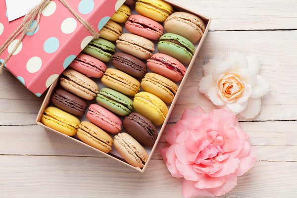 Macaron and flowers on the table Stock Photo