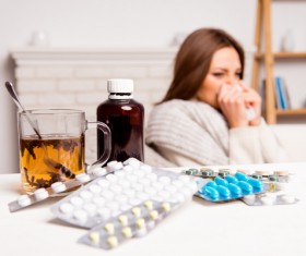 Sick woman with desktop medicine Stock Photo 03