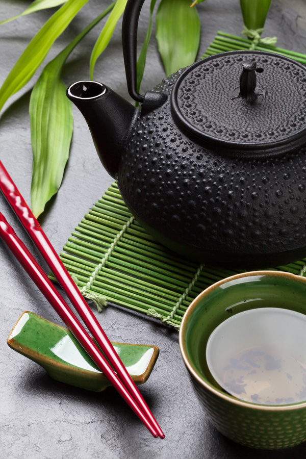 Tea pot with chopsticks Stock Photo