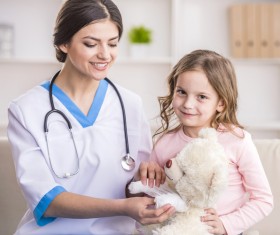A little girl playing with a pediatrician Stock Photo 01