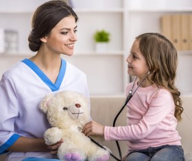 A little girl playing with a pediatrician Stock Photo 02