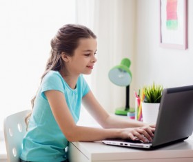 A little girl typing on a tablet Stock Photo