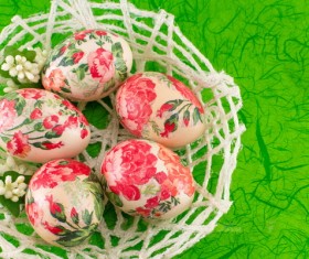 Basket decorated eggs and green background Stock Photo