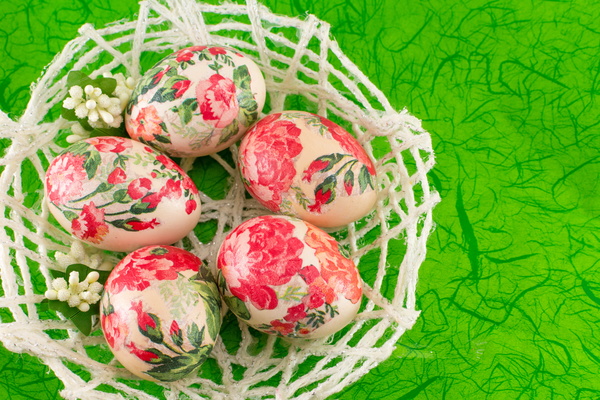 Basket decorated eggs and green background Stock Photo