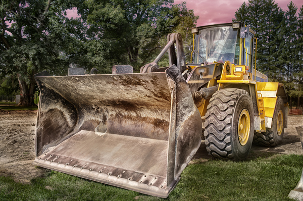 Bulldozer parked beside the forest Stock Photo
