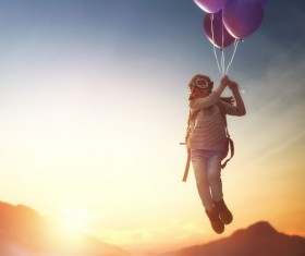 Child flying on balloons HD picture