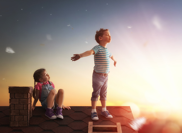 Climb the little boy on the roof with the little girl Stock Photo