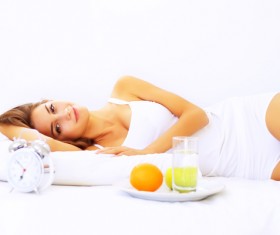 Food and bed smiling girl Stock Photo