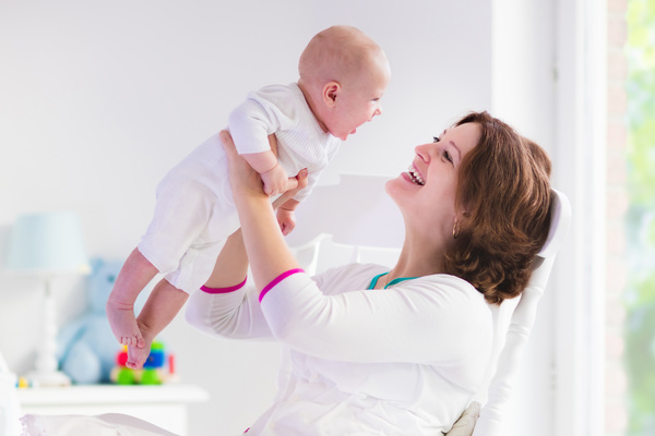 Funny baby laughing mother Stock Photo