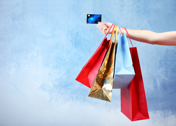 Holding a shopping bag with a bank card for a woman Stock Photo 02