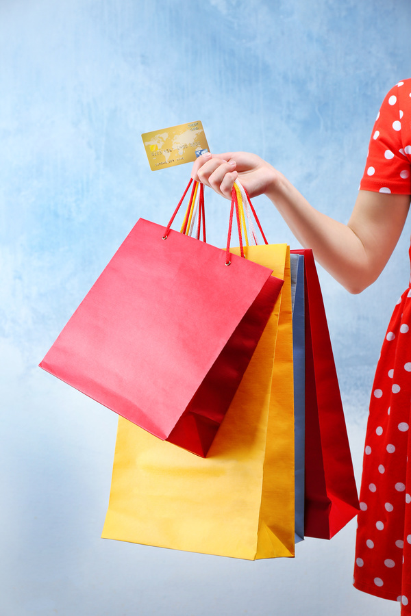 Holding a shopping bag with a bank card for a woman Stock Photo 03