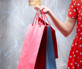 Holding a shopping bag with a bank card for a woman Stock Photo 04
