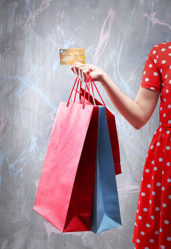 Holding a shopping bag with a bank card for a woman Stock Photo 04